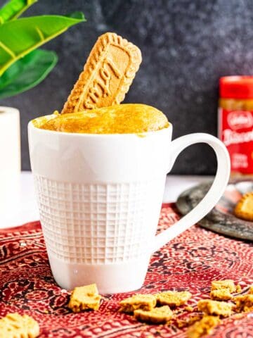 biscoff mug cake with biscoff biscuits around.