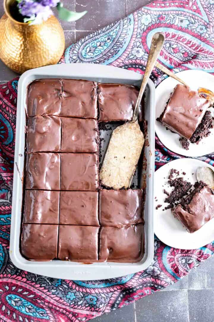 overhead shot of the big pan with chocolate mayonnaise cake pieces in it along with a golden spoon.