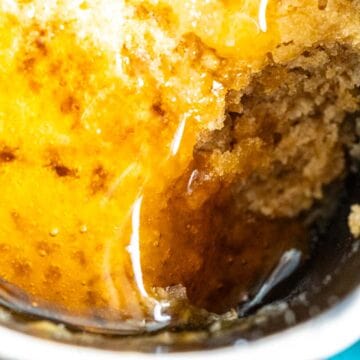 honey mug cake in a mug with poured honey over it.