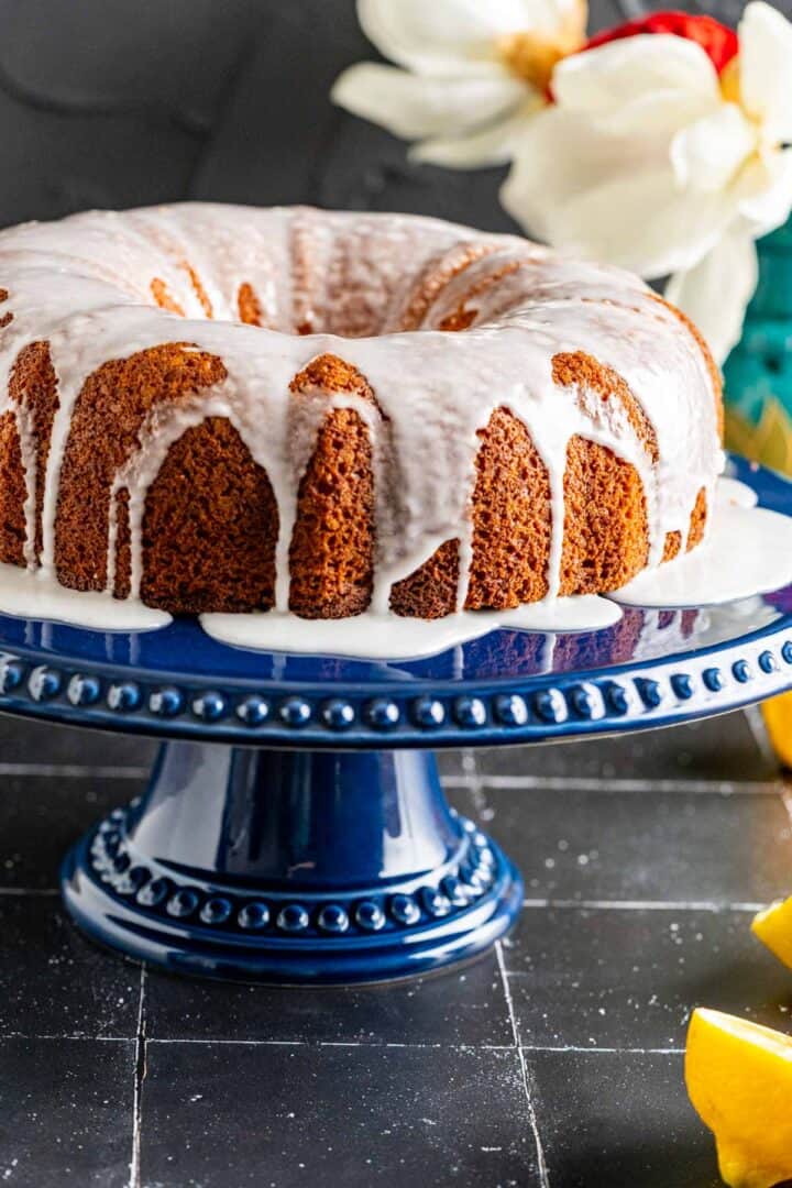 close shot of lemon cake with lemon glazed poured over it.