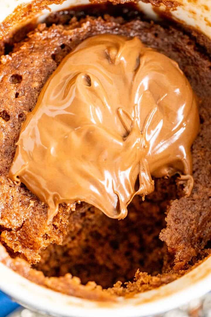 close shot of a dollop of nutella placed over the nutella mug cake.