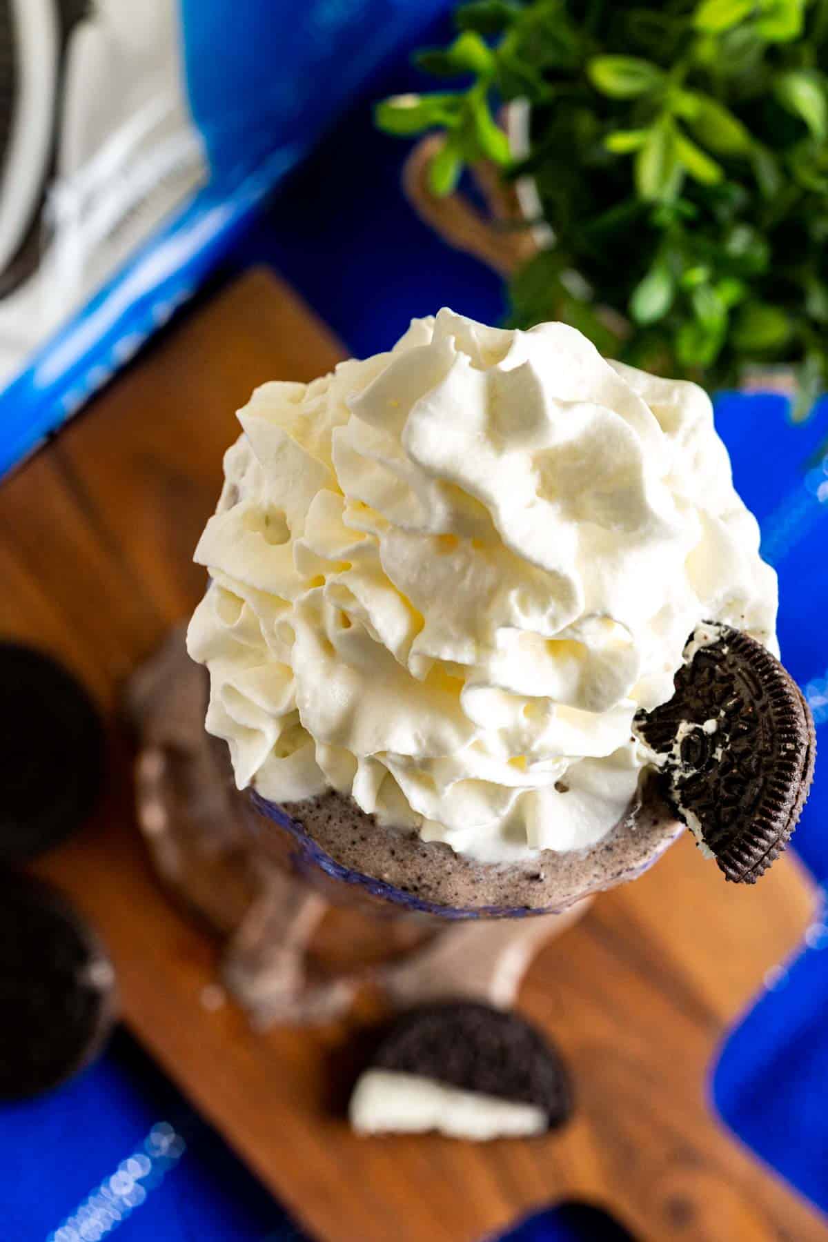 Banana Oreo milkshake decorated with whipped cream on the top.