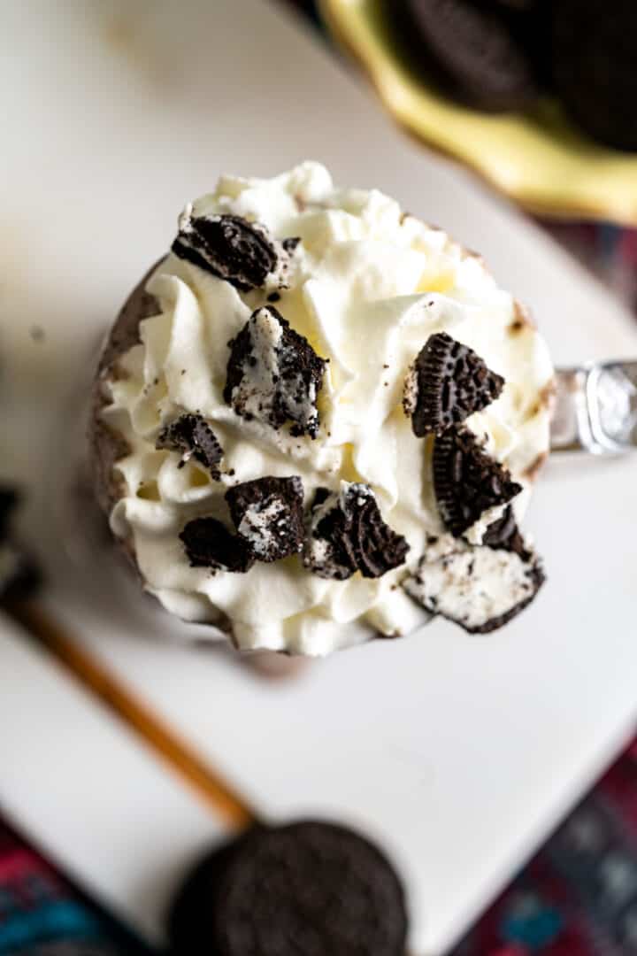 over the head shot of oreo milkshake on colorful table cloth.