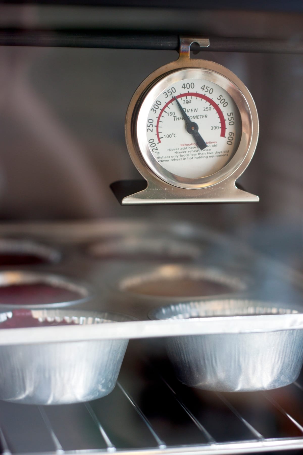 an oven thermometer in the oven showing the temperature.