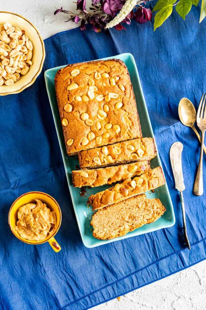 from the top shot of the peanut butter slices in a plate over blue table cloth.