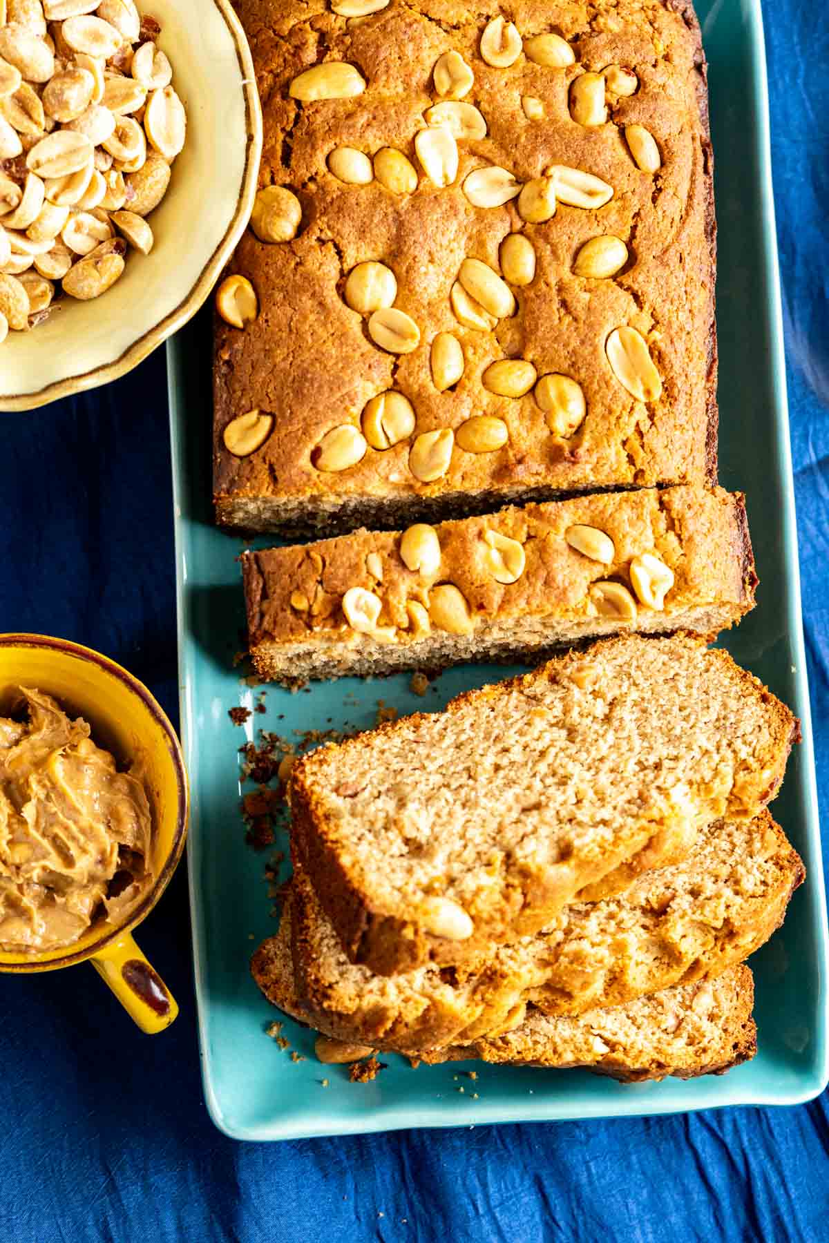 Peanut butter bead slices sitting in an aqua color rectangular plate.