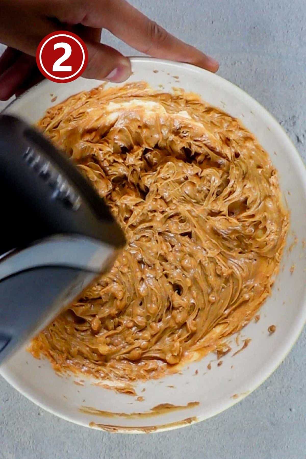 Beating the butter and peanut butter in a large bowl.