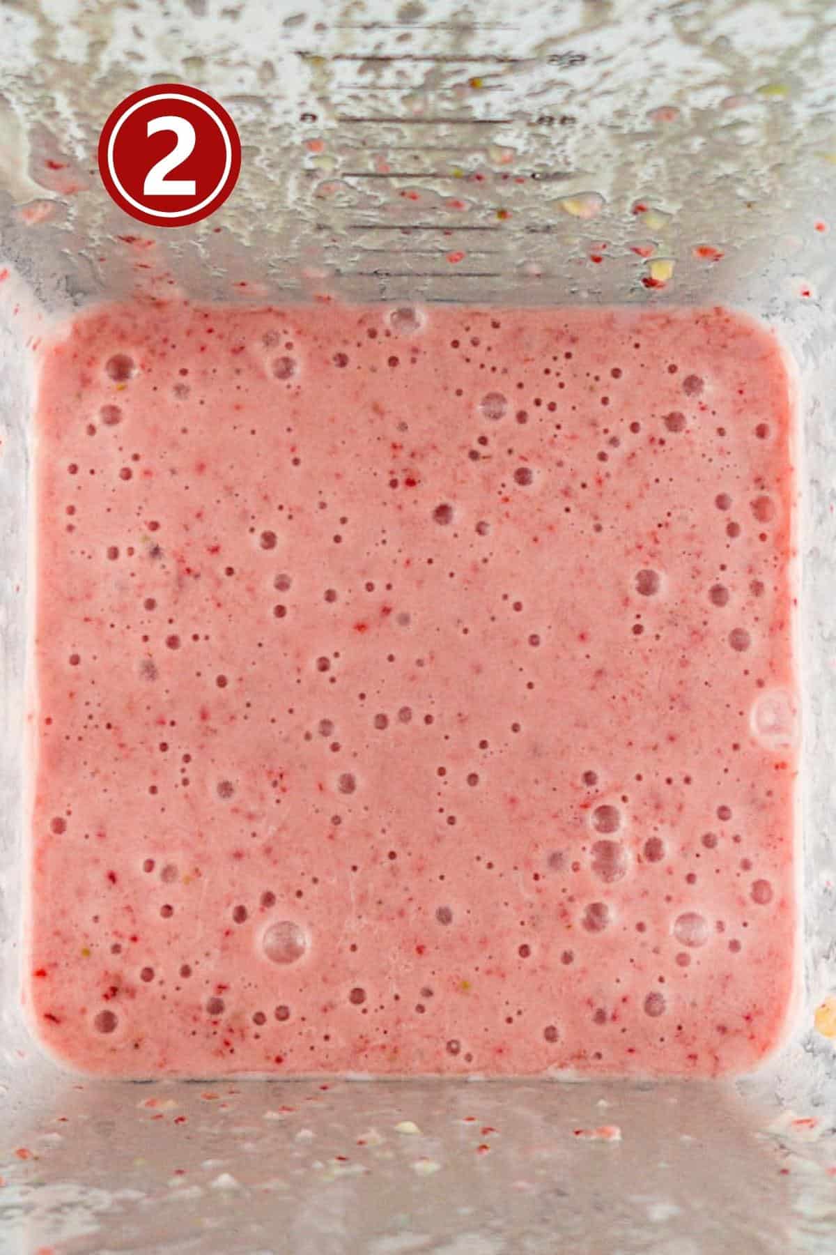 Strawberry milkshake in the blender jar. 