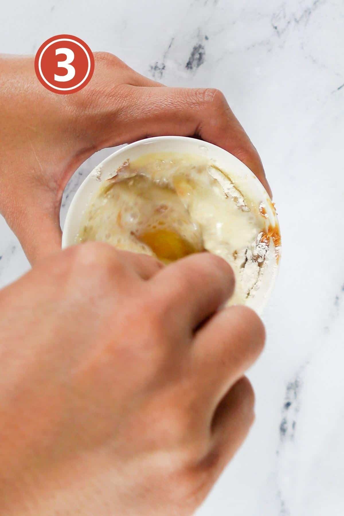 Mixing the mug cake batter in the mug.