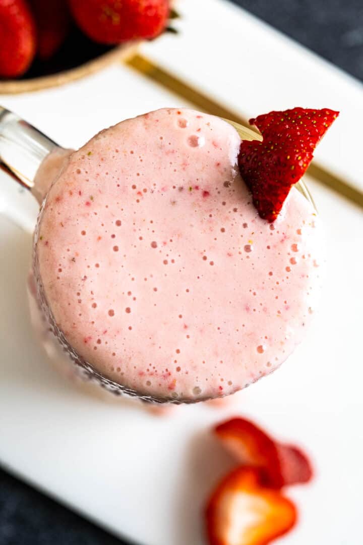 overhead close shot of strawberry banana milkshake on the counter.