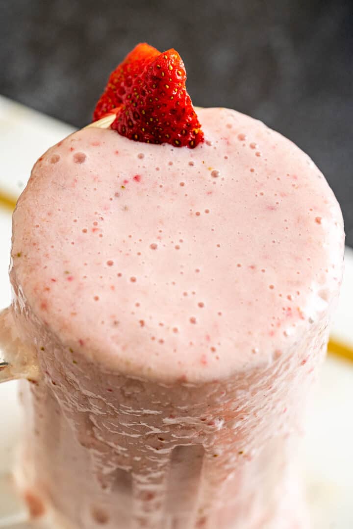 milkshake overflowing from the serving glass.