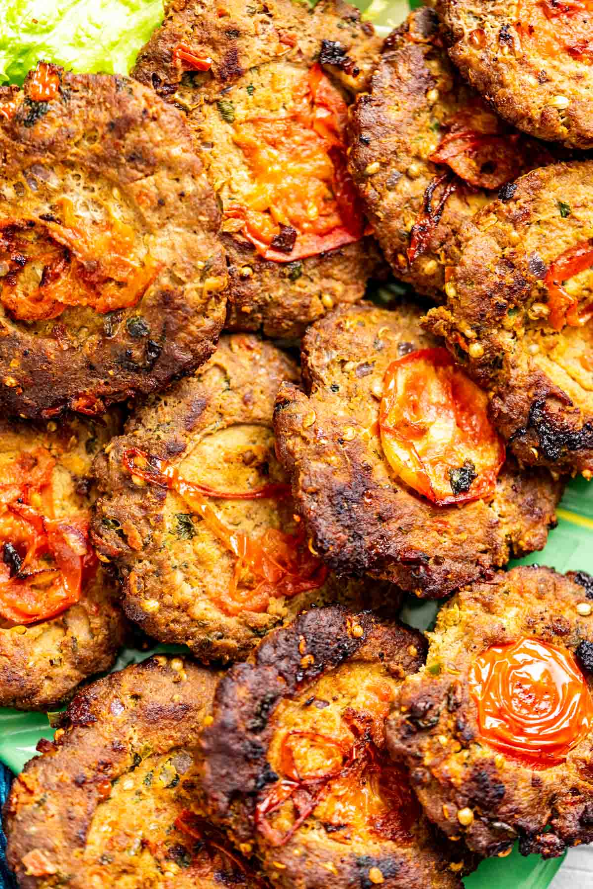 Chapli kebabs placed in a big green plate.