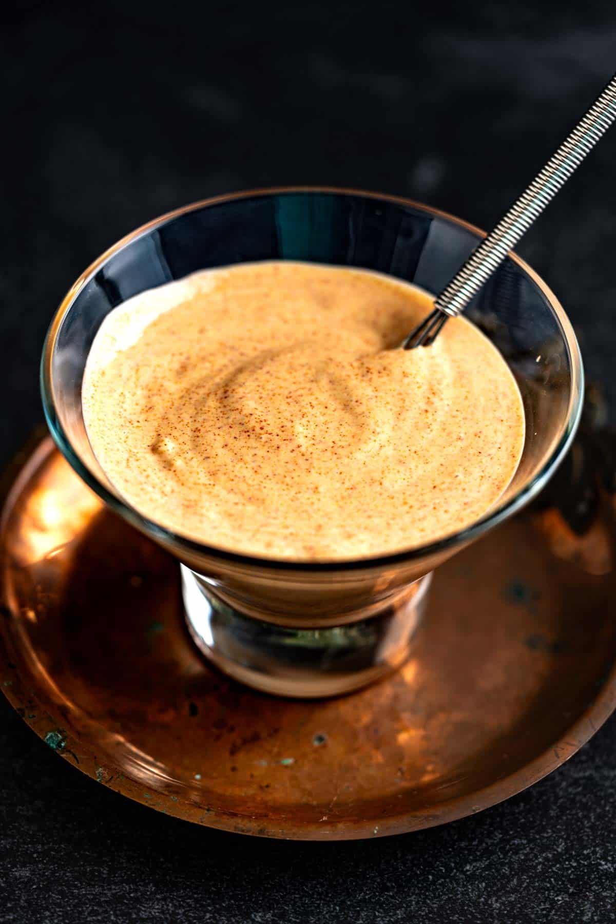 Mayonnaise with peri peri in a bowl with a small whisk inside the bowl.