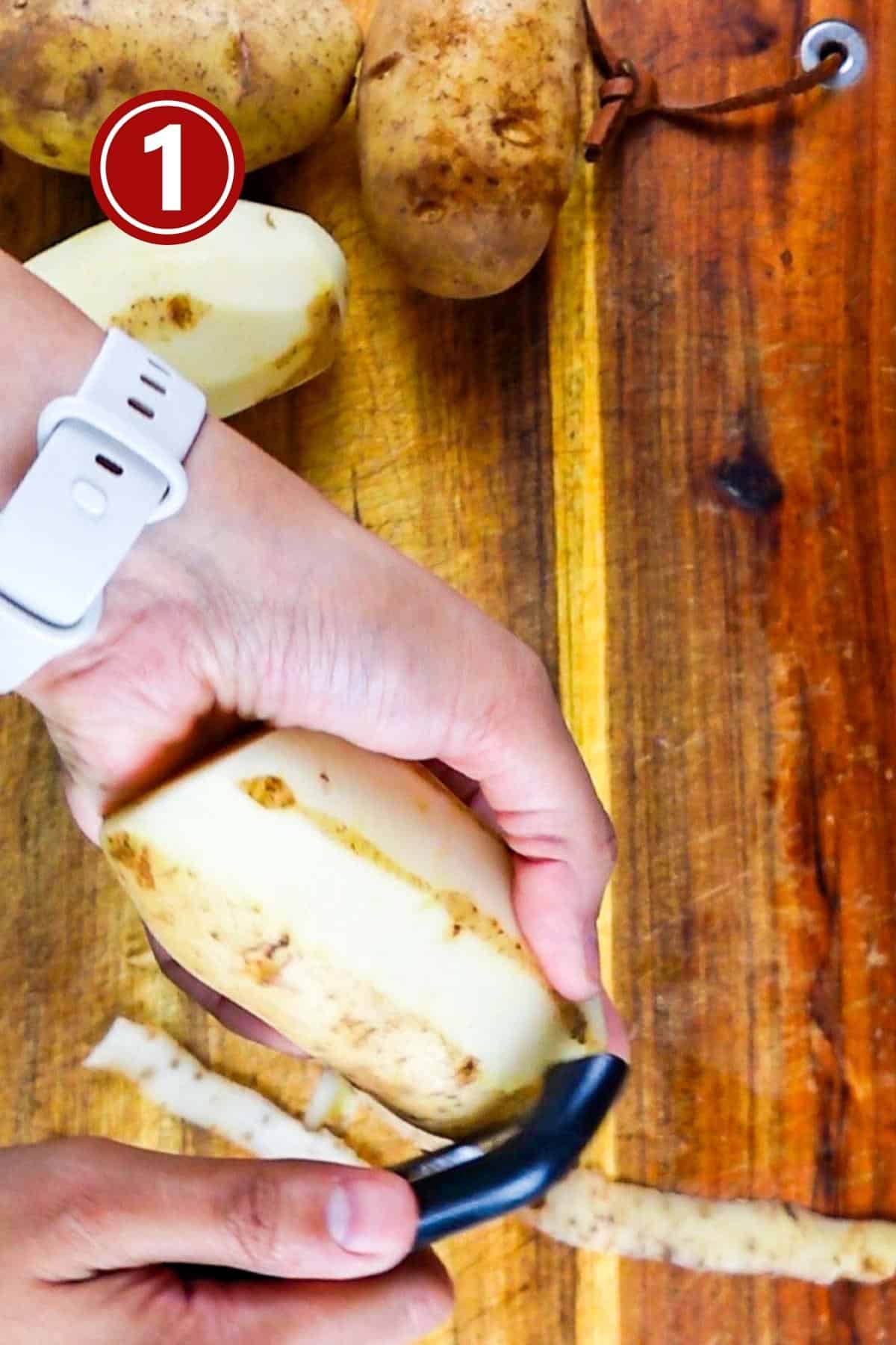 Peeling the russet potatoes using a peeler.