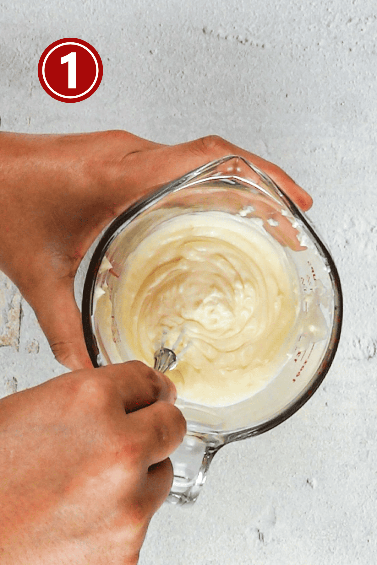 Whisking up the mayonnaise with a small whisk.