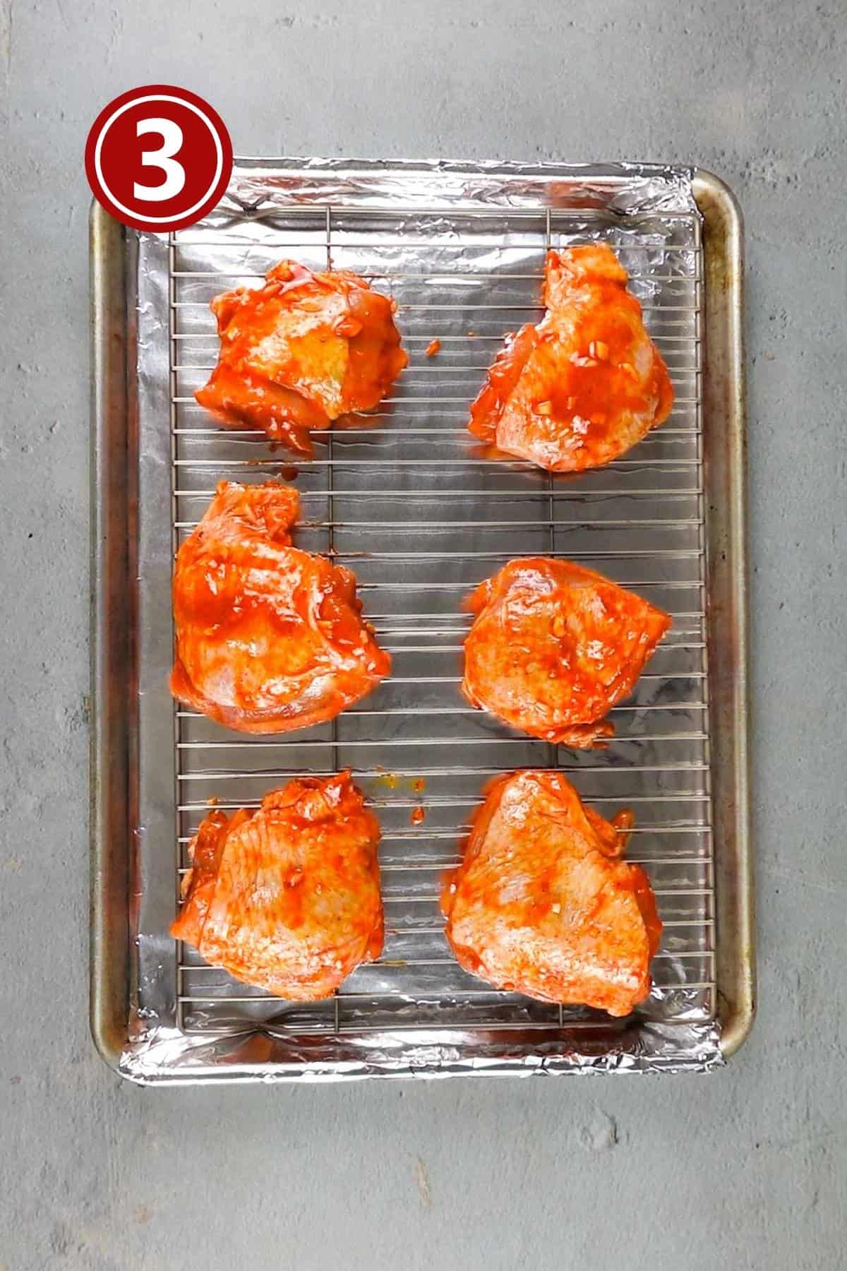 Marinated thighs placed on the baking tray ready to go in the oven.