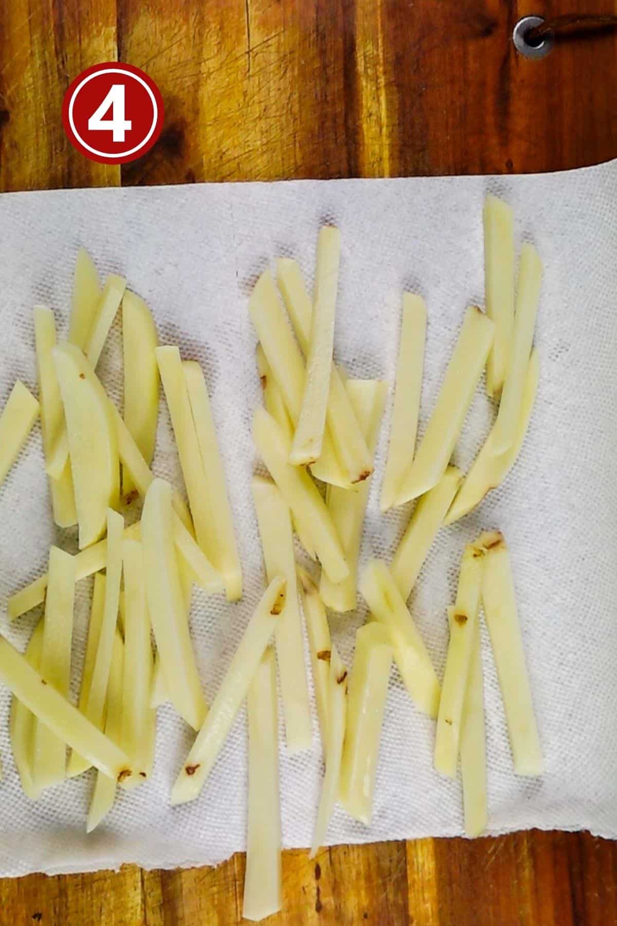 Fries spread on the paper towel as a single layer.