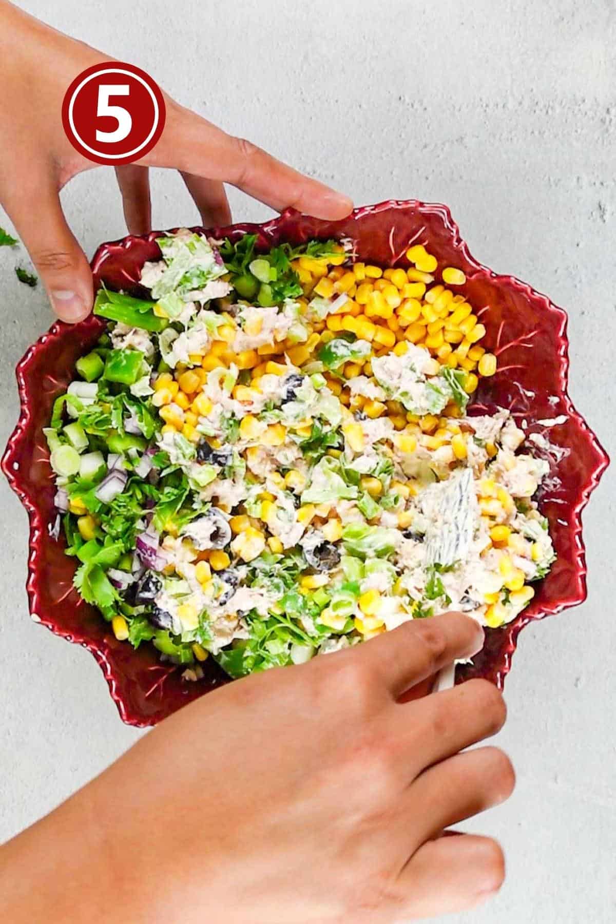 Mixing up the ingredients for the salad.