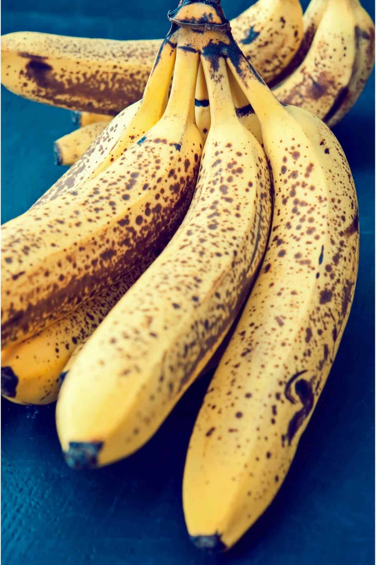 a bunch of bananas with brown spots on it.