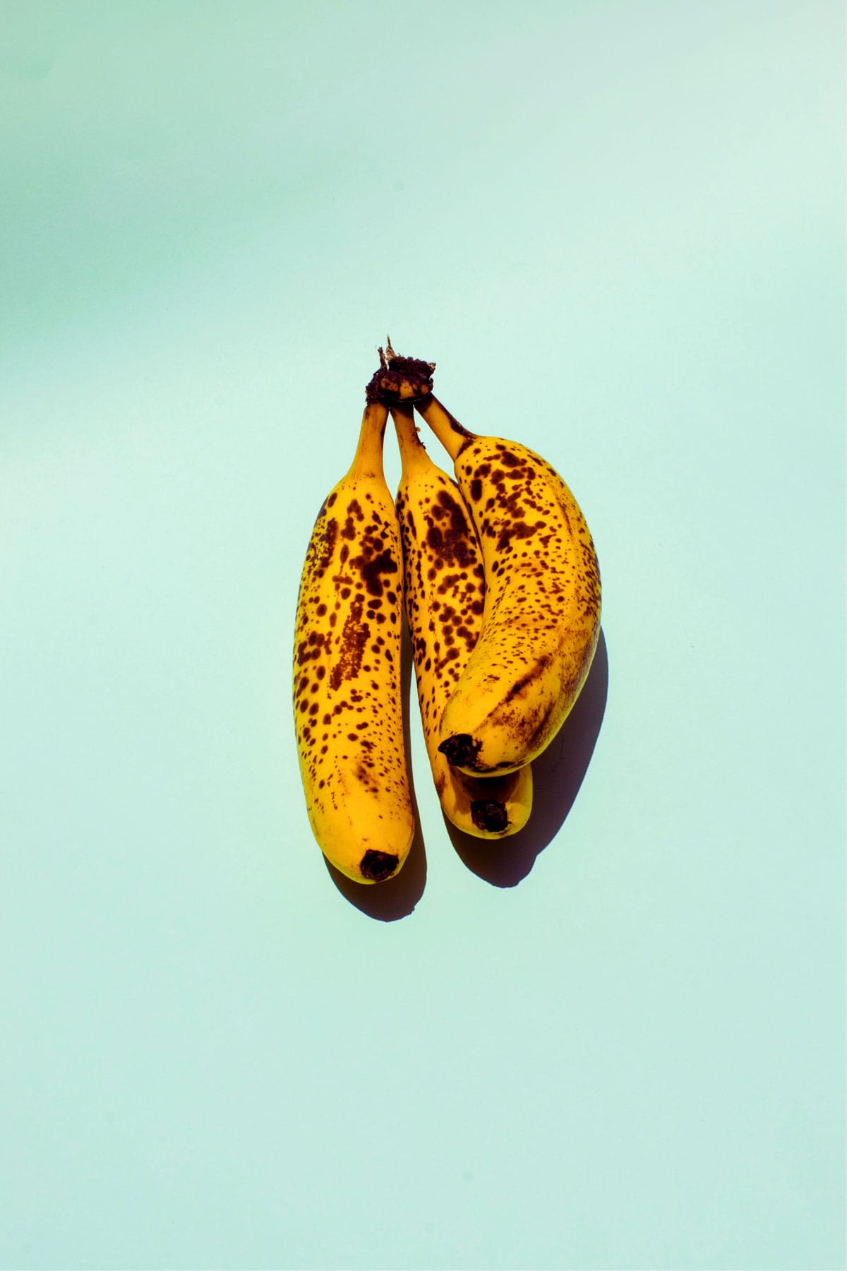 three bananas with brown spots.