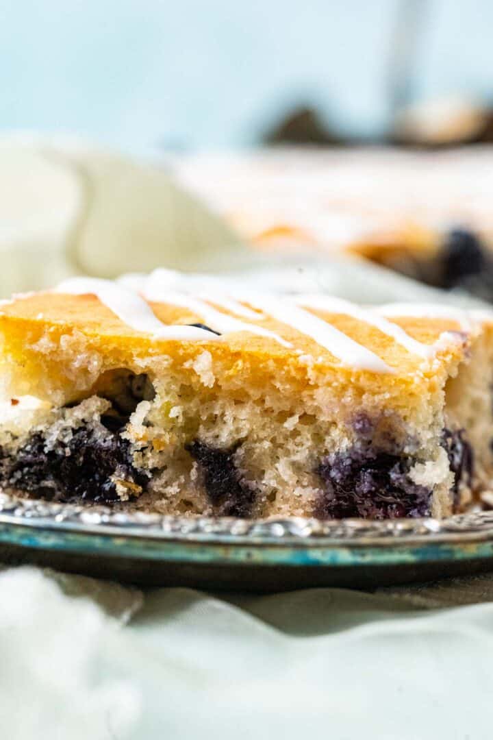 close shot of sheet cake showing the texture with blueberries inside.