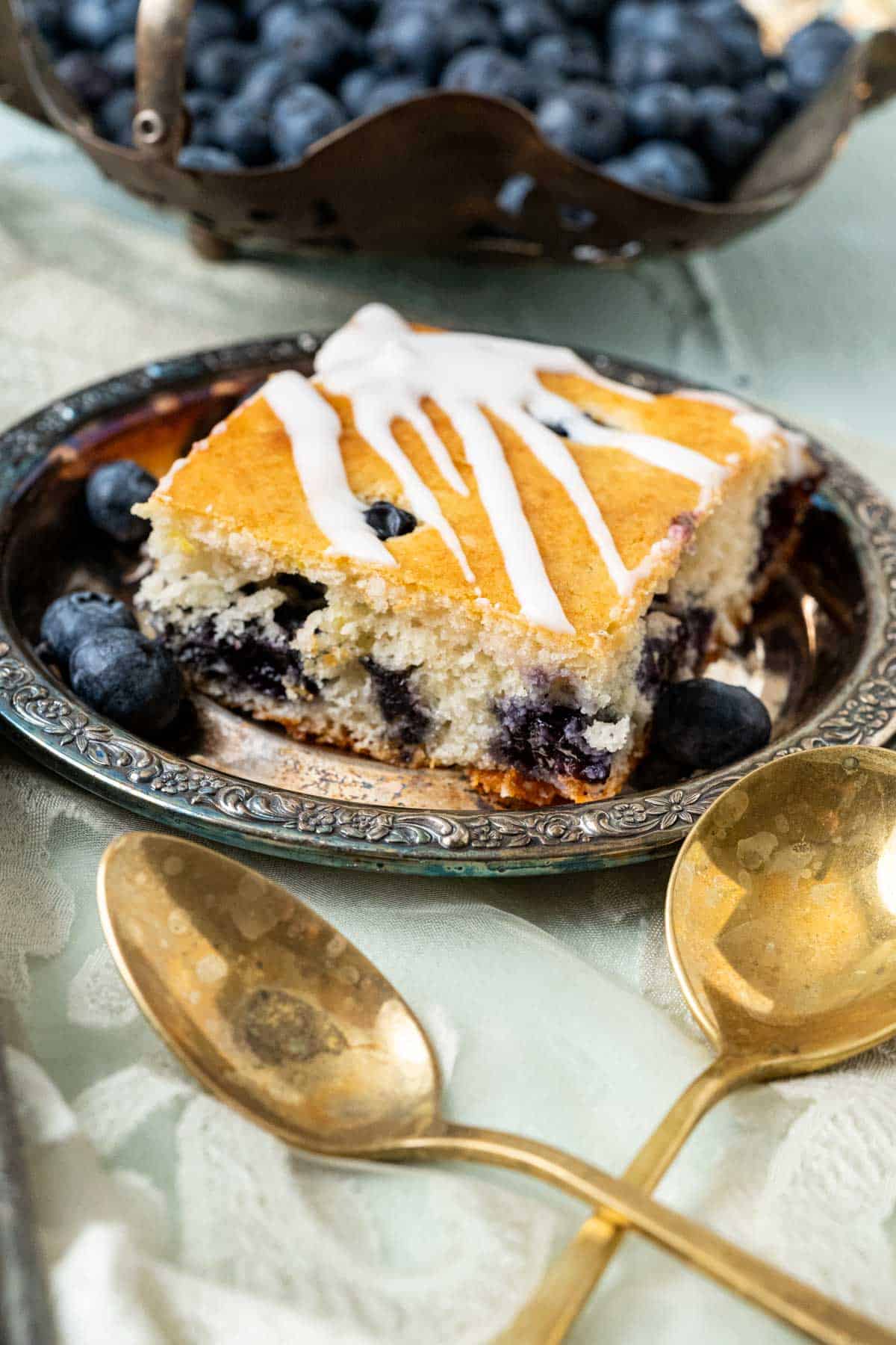 shot of one piece of cake in an old antique silver small plate.