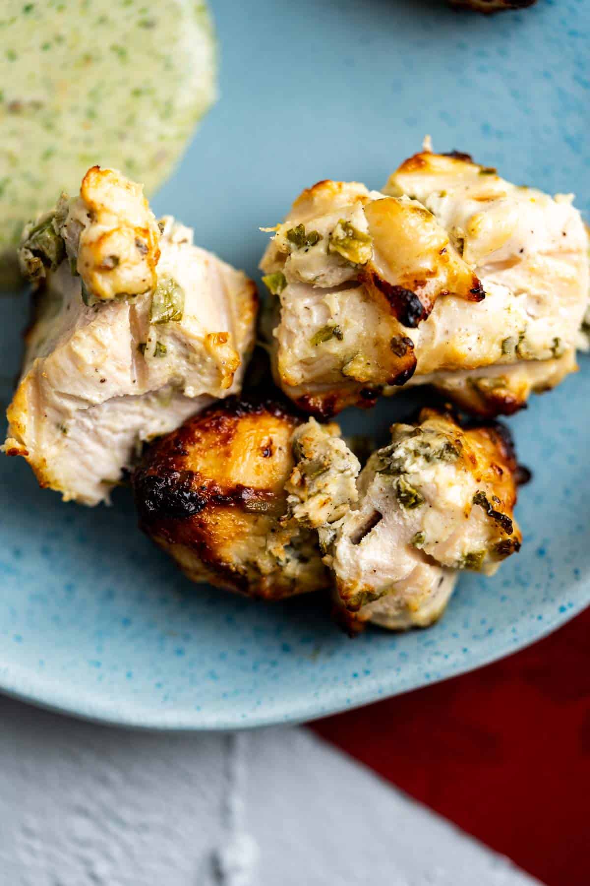 Three malai boti on a blue plate.