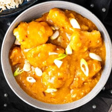 overhead shot of chicken with sauce in a bowl.