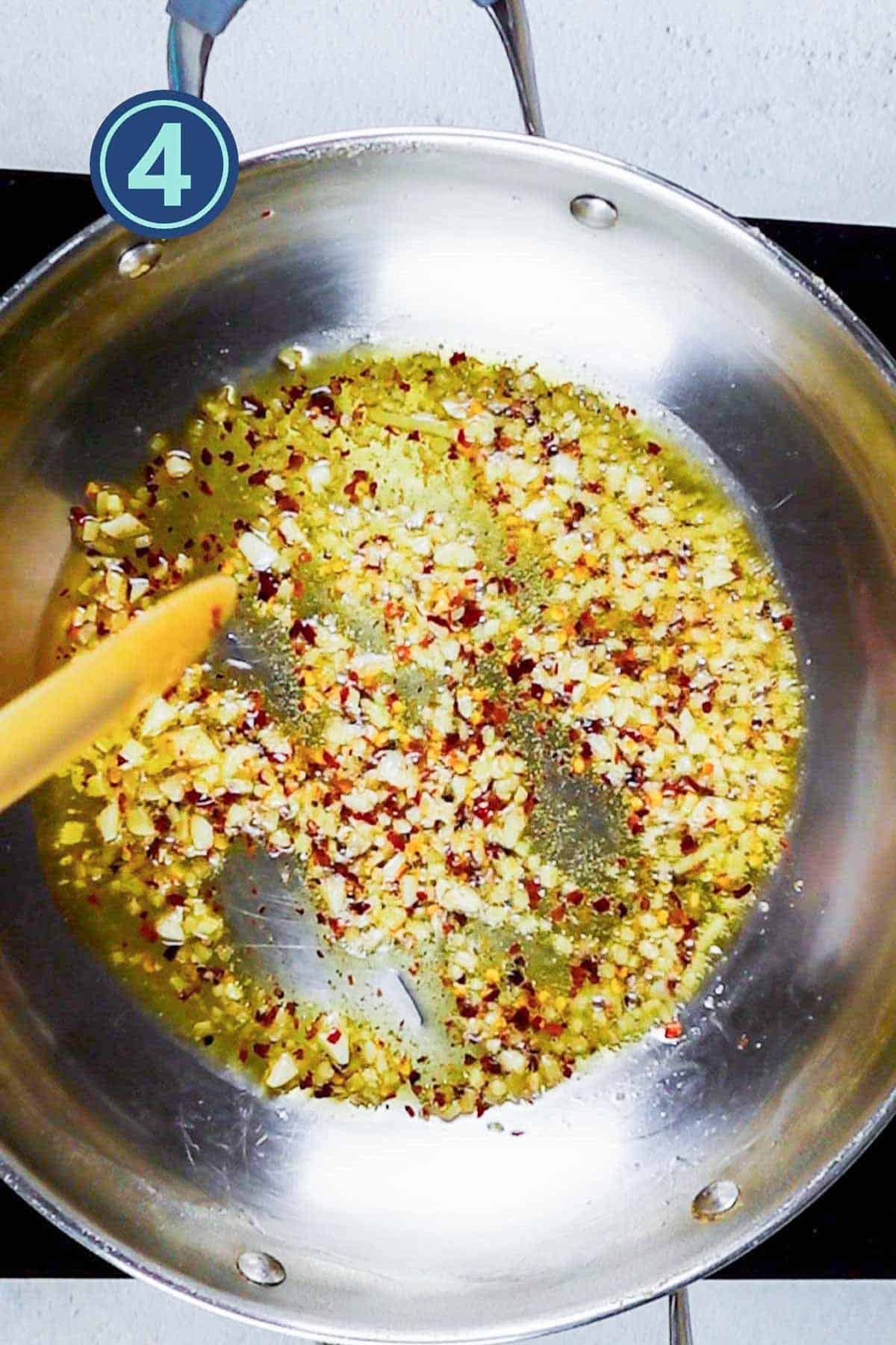 Garlic ginger with red chili powder in frying pan.