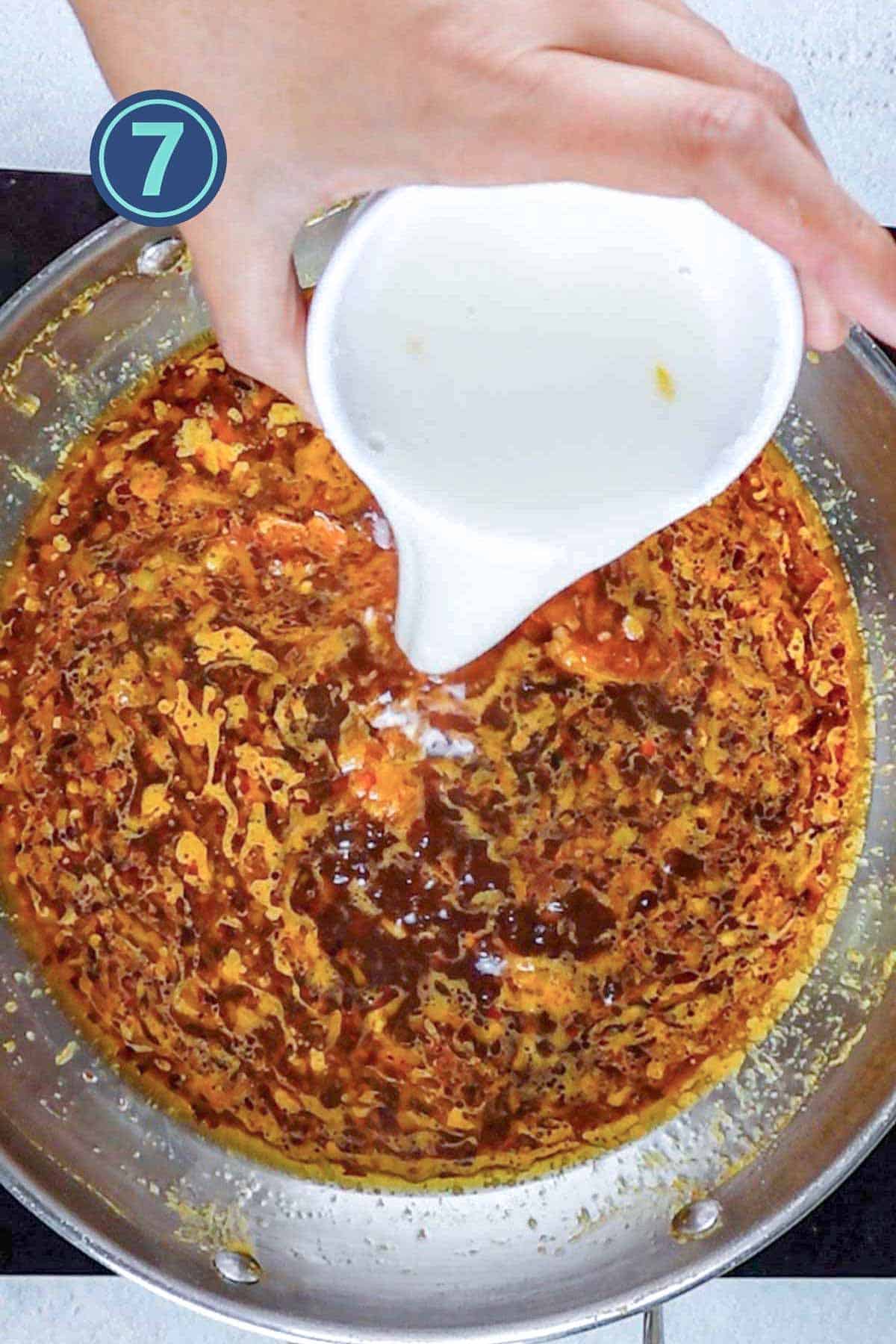 Adding corn flour in the orange sauce mixture.