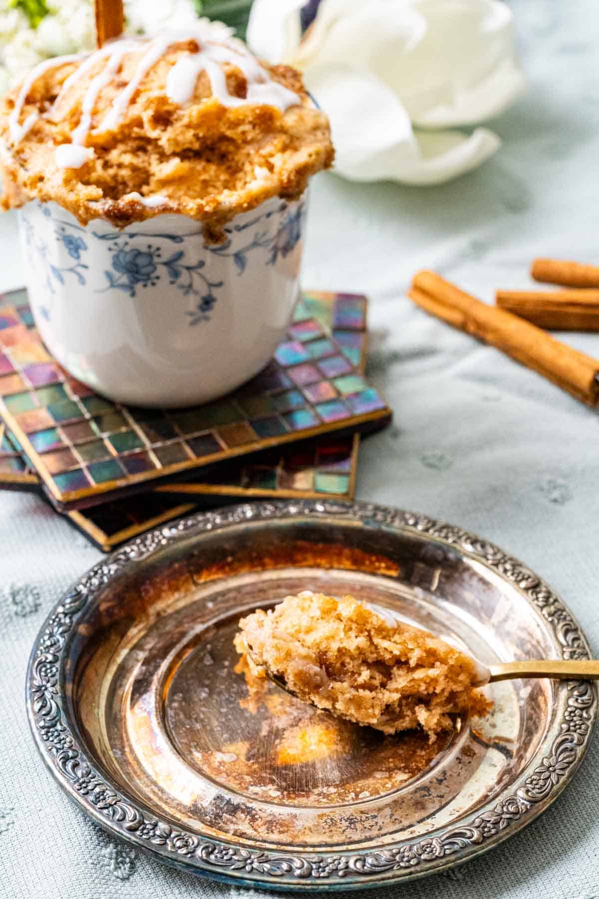 Spoonful of cinnamon roll cake showing the texture of the cake.