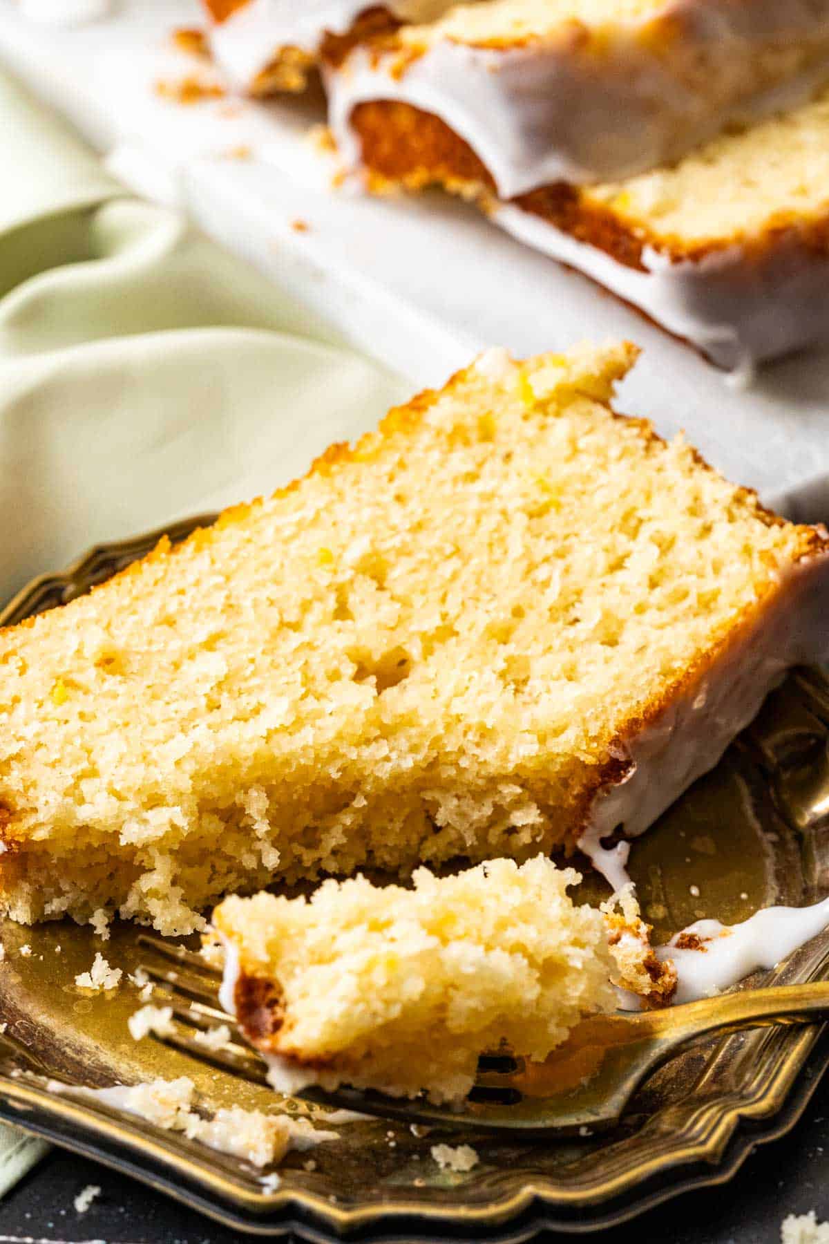 Lemon loaf slice bite in a spoon showing the texture of the cake.