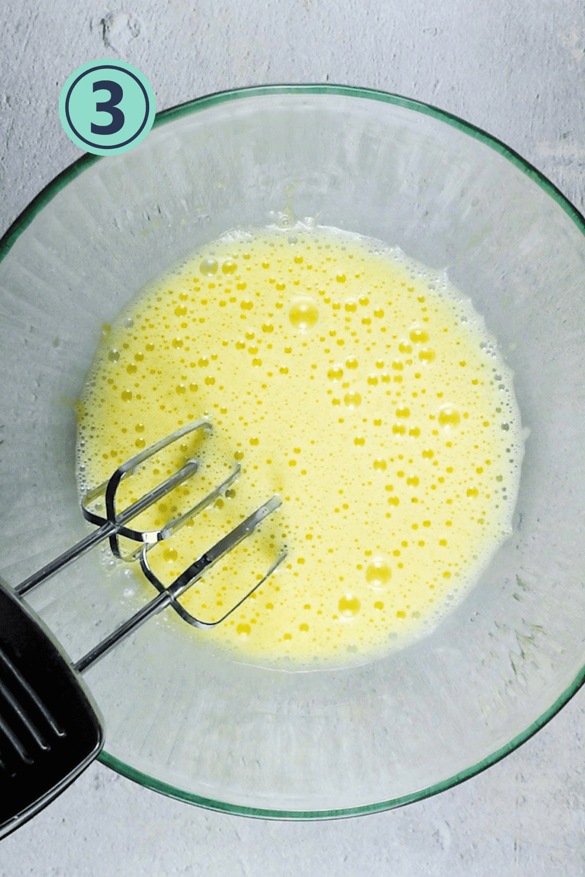 Beaten eggs in a medium bowl.