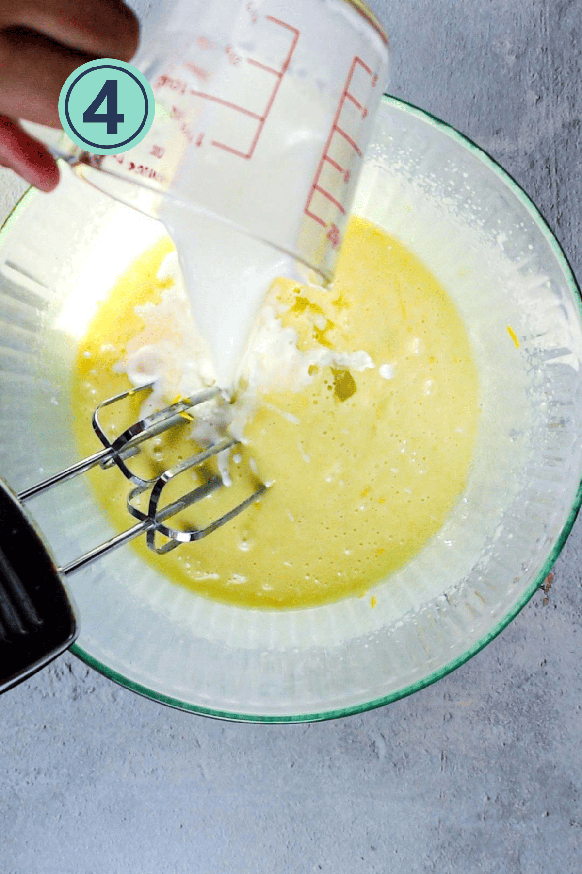 Adding wet ingredients into the butter and sugar mixture.