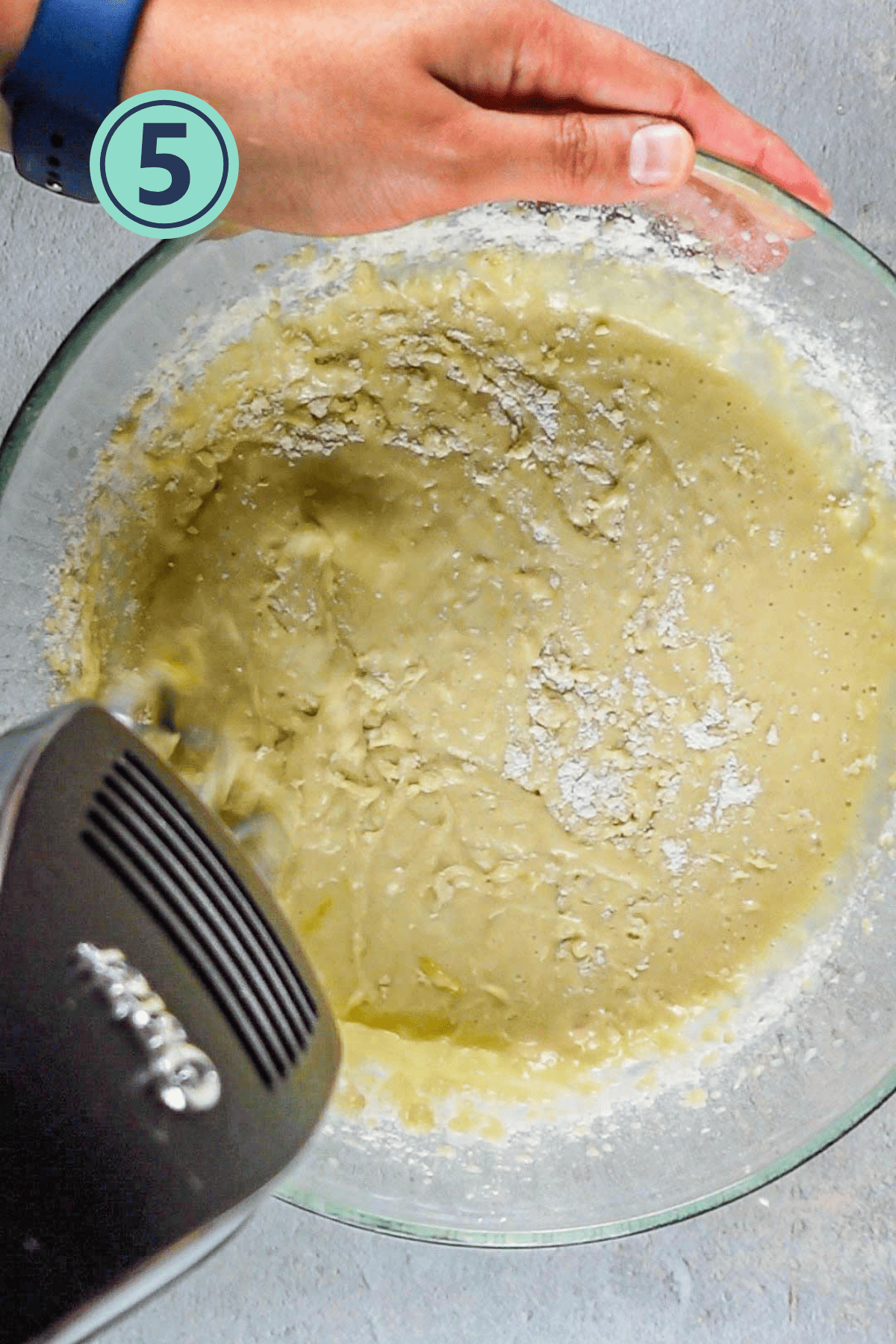 Incorporating dry ingredients into the wet ingredients.