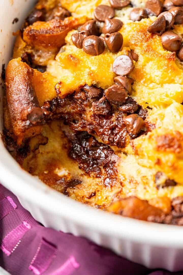 Chocolate chips sprinkled over pudding's bread pieces.